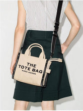Load image into Gallery viewer, Marc Jacobs The Leather Small Tote - Merlot, Red - Shown in Warm Sand
