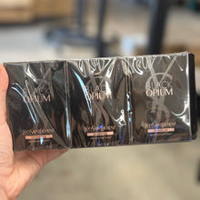 Load image into Gallery viewer, YSL Black Opium Le Parfum 12 x 1.2ml / 0.04 oz vials full sealed sleeve sample pack on blurred background - women's intense gourmand vanilla coffee fragrance
